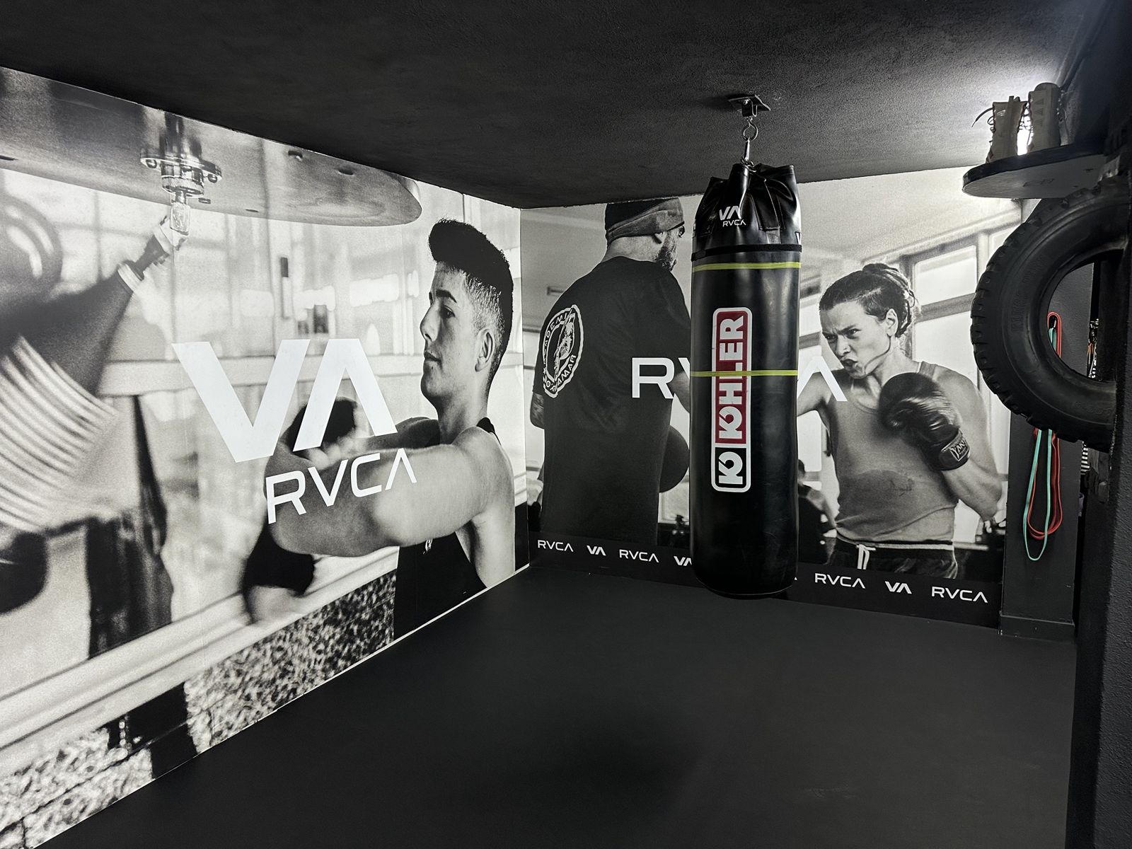 Interior do EBC Home Gym, com saco de boxe e paredes com fotografias de boxe